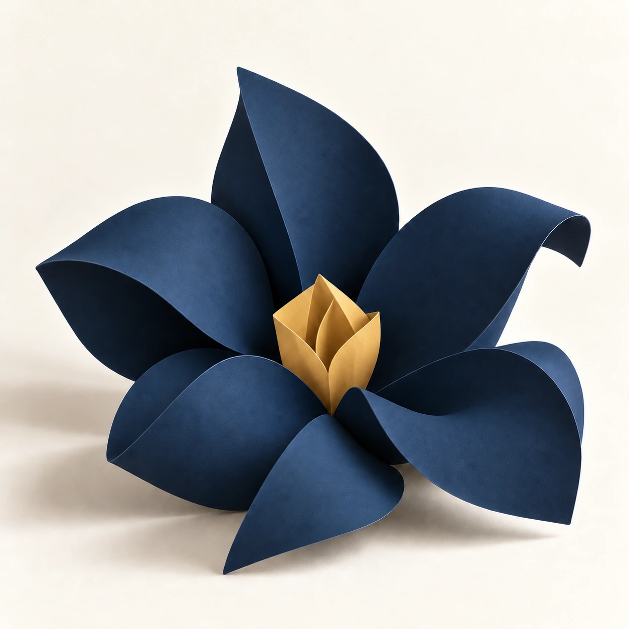 A sculptural bloom made from textured navy paper petals around a gold center.